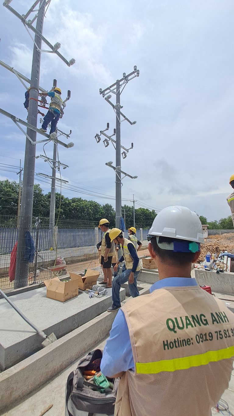 Construction site with contractors discussing contract types for transformer station.